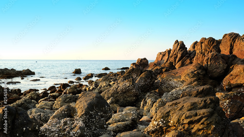 Stone reef beside beach and summer clear sky. Stone reef beside beach and summer clear sky.