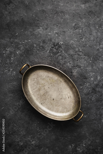 Empty old pan dark stone background top view photo