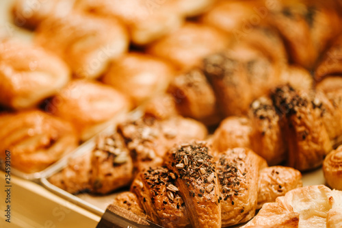 Closeup photo of gold croissants on the conunter in bakery