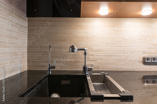 Fényképezés Black artifical stone countertop with black sink and two faucets