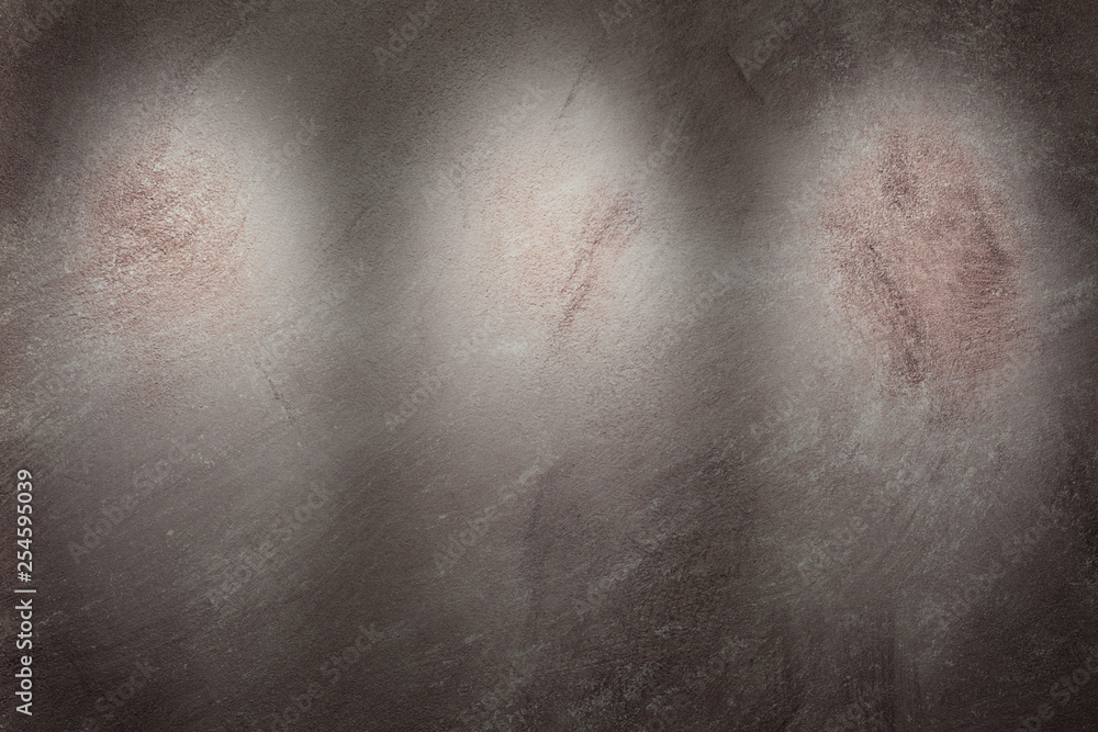 Beige textured concrete wall with lightening from three spotlights, front view. Beige textured concrete wall with lightening from three spotlights, front view.