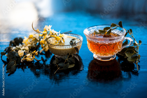 Saragava or drumstick or Moringa oleifera flower on wooden surface along with its paste and herbal extracted tea. photo