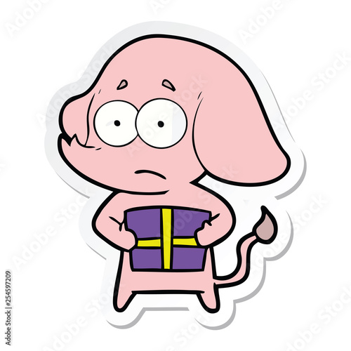 sticker of a cartoon unsure elephant with christmas present