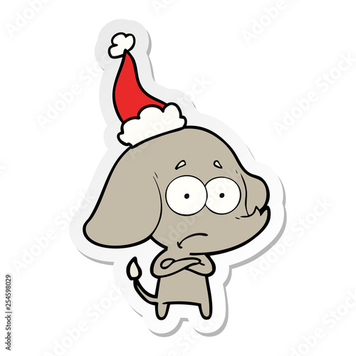 sticker cartoon of a unsure elephant wearing santa hat