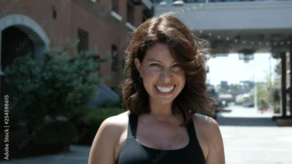 Smiling and laughing at camera from a young woman outside. Smiling and laughing at camera from a young woman outside.