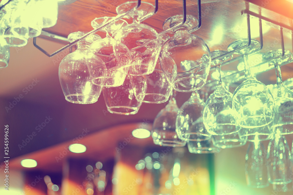 Empty glasses hanging above the bar in the restaurant. Empty glasses hanging above the bar in the restaurant.