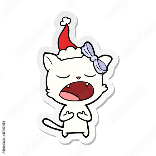 sticker cartoon of a cat meowing wearing santa hat