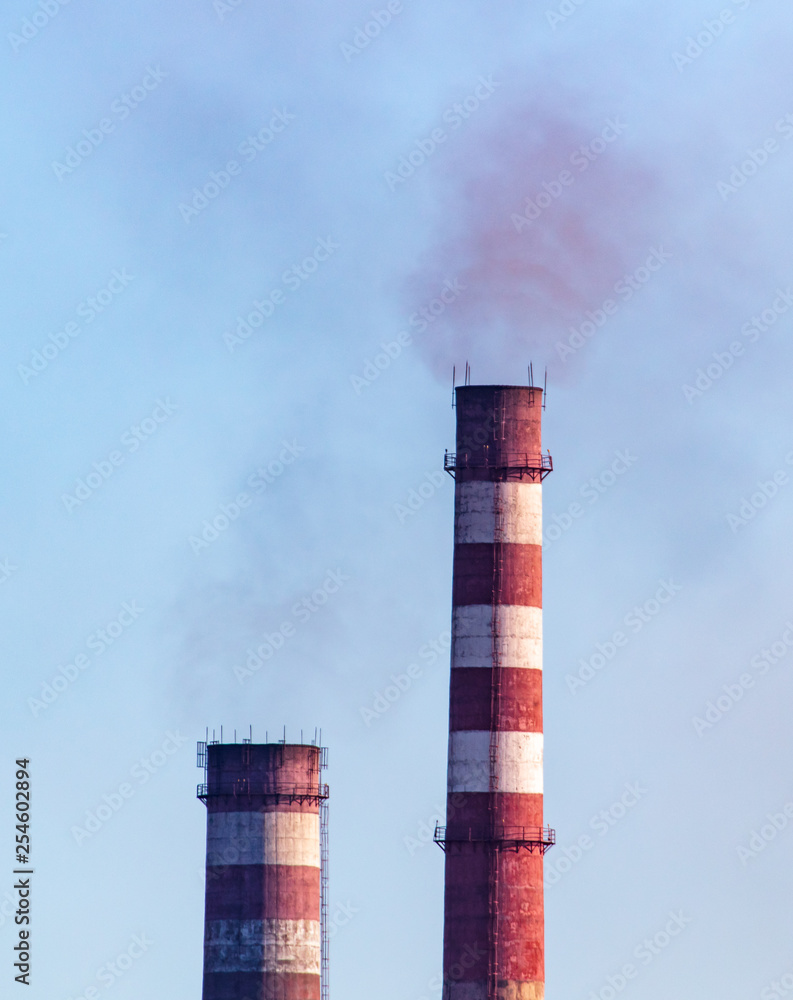 Smoke from pipes at the factory against the sky