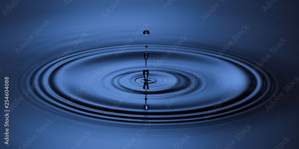 Blue water drop falling down. Blue abstraction background. Blue water drop falling down. Blue abstraction background.