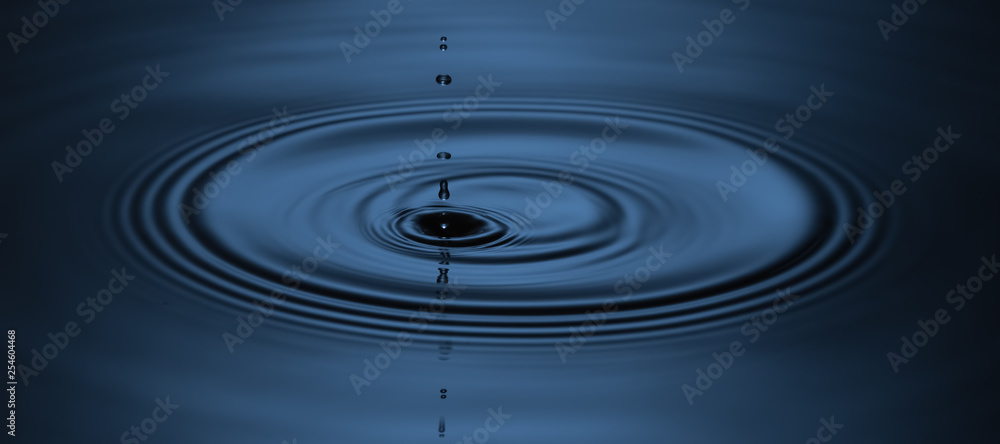 A drop falls to the left of the center and diverging circles. A drop falls to the left of the center and diverging circles.