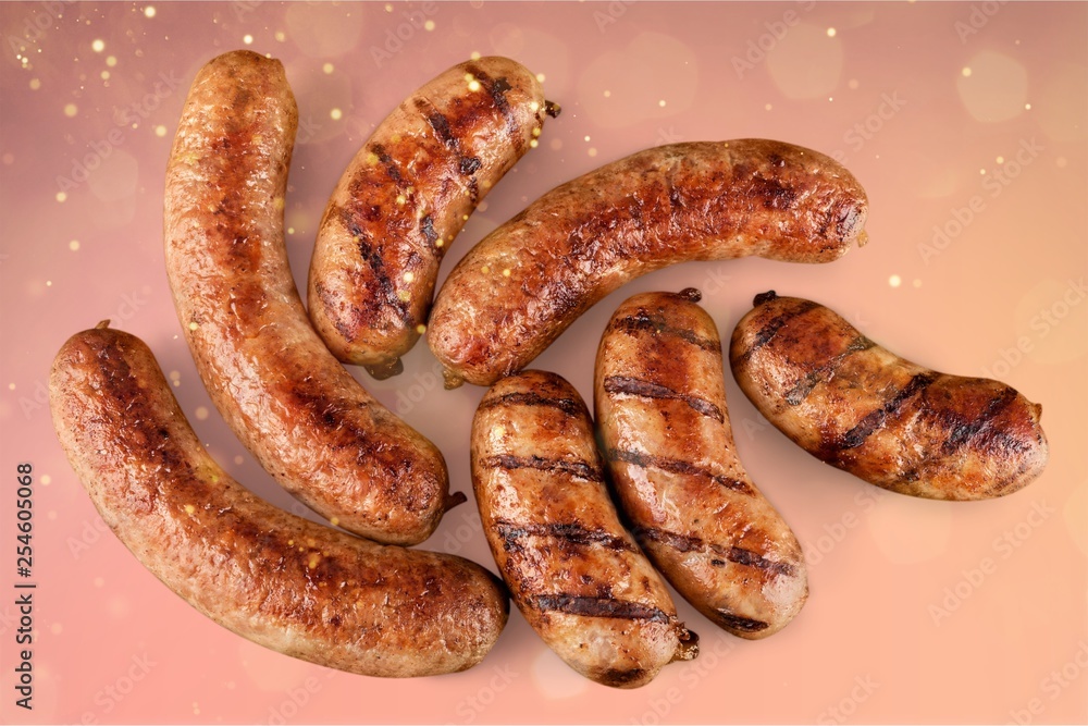 Obraz premium Roasted sausages on white background