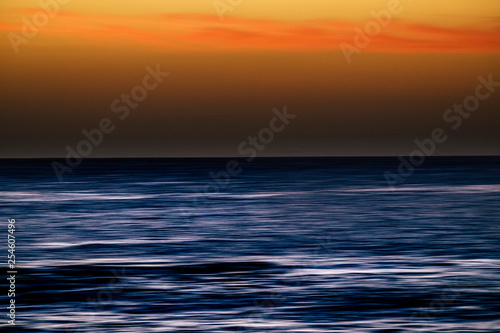 Water with stretch movement motion effect and coloured sky - sunset time with touristic and vacation concept