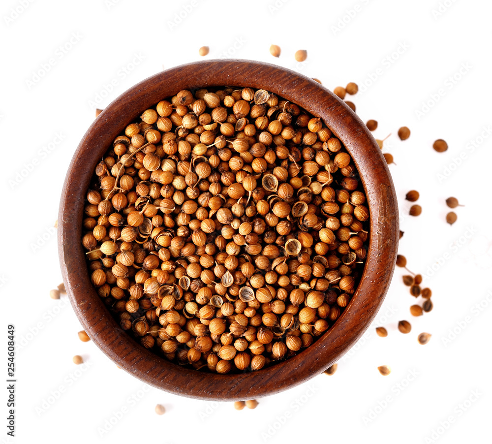 Coriander seeds in Bowl on white background, top view Coriander seeds in Bowl on white background, top view