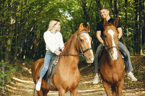 couple with horses © hetmanstock2
