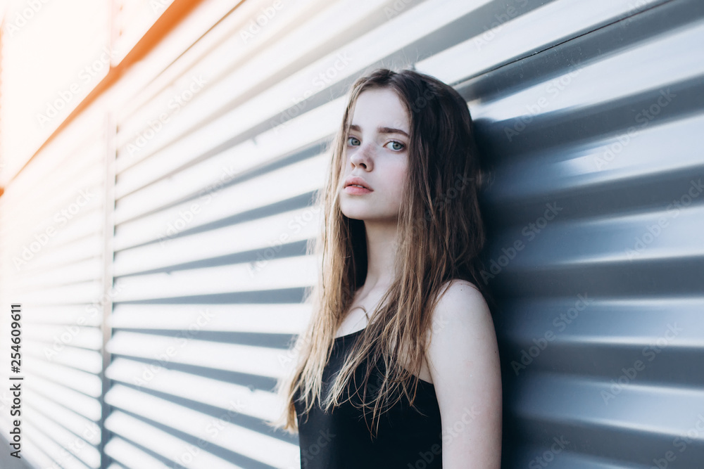 Cute cheerful portrait of young teenage girl outdoors in the street . Emotions, portrait, beauty concept Cute cheerful portrait of young teenage girl outdoors in the street . Emotions, portrait, beauty concept