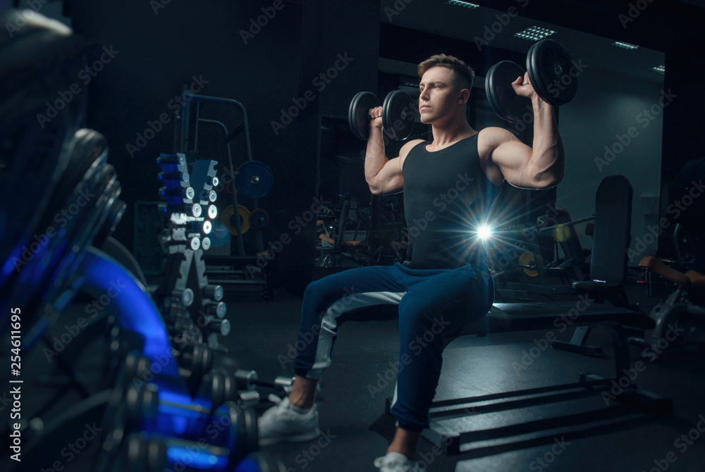 the sporty boy trains with dumbbells the sporty boy trains with dumbbells