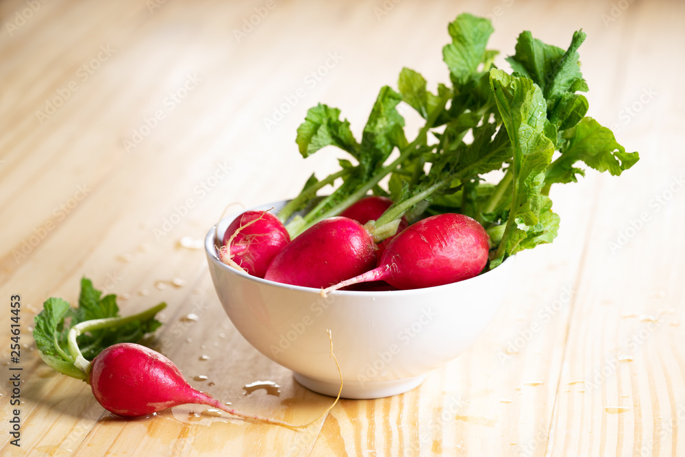 Fresh red radishes on wooden table Fresh red radishes on wooden table