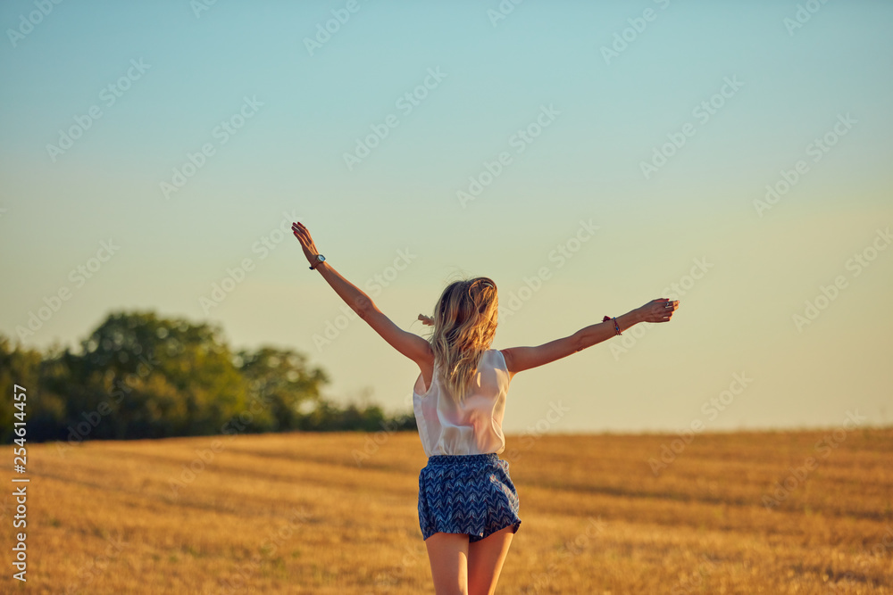 Cute young woman jumping in a wheat field. Cute young woman jumping in a wheat field.