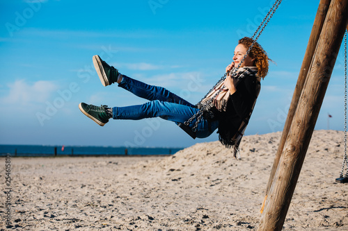 Girl on a swing on the beach.  photo