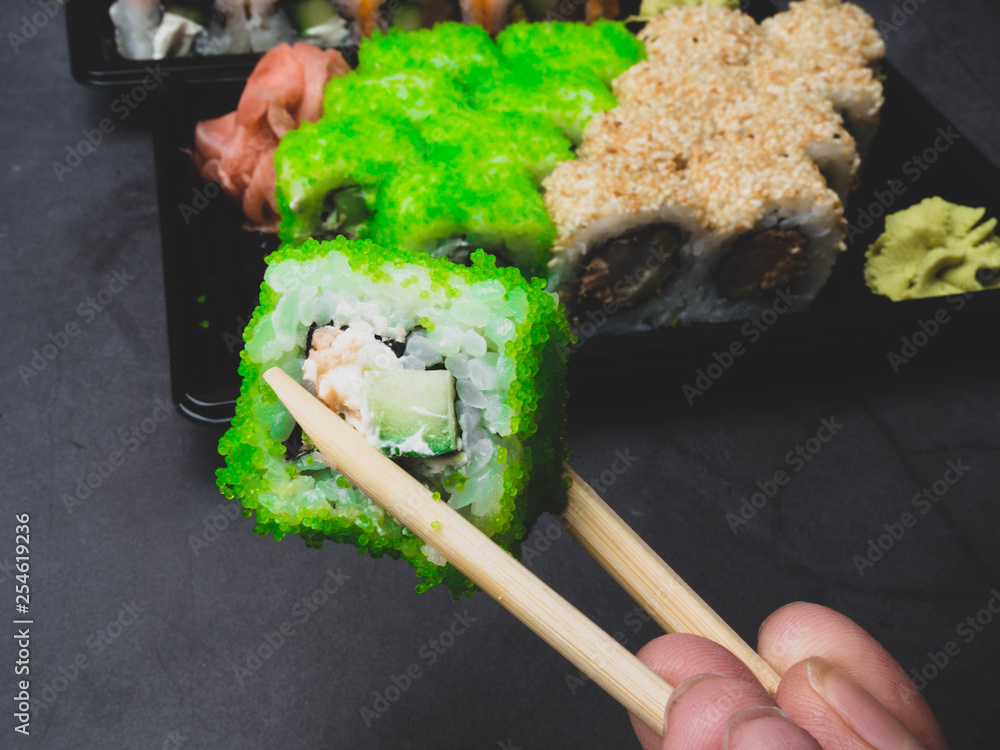 eating sushi with chopsticks, selective focus eating sushi with chopsticks, selective focus