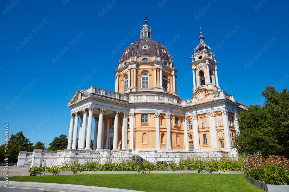 Superga basilica on Turin hills with flowerbed and clear blue sky in a sunny summer day in Italy