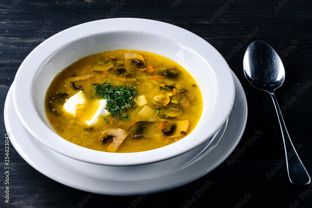 mushroom soup in a cafe, lunch menu on a dark table mushroom soup in a cafe, lunch menu on a dark table