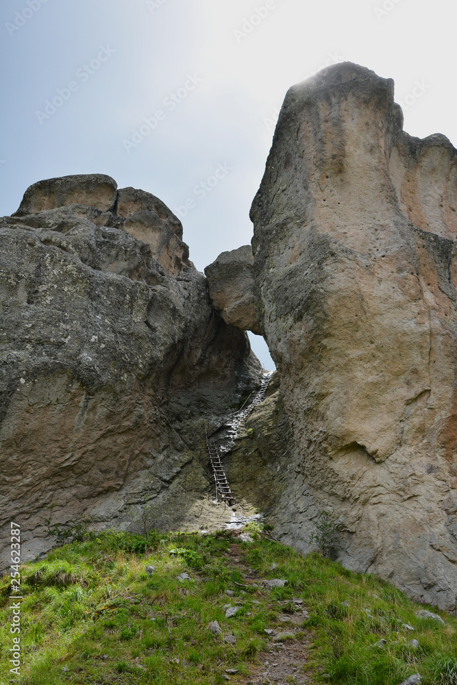 Unique natural rock formation consisting of big boulder stuck between two rocks in the Rhodope mountain in Bulgaria (called in Bulgarian Karadjov Kamak)