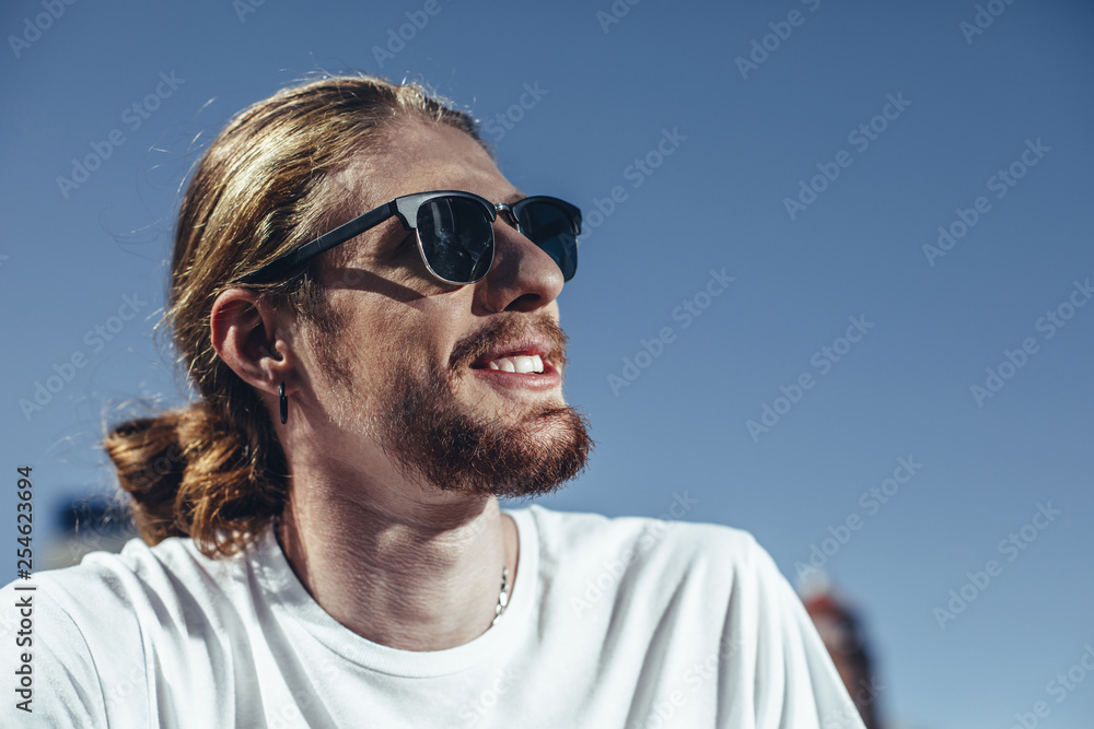 Handsome bearded guy enjoying the view of beautiful blue sky Handsome bearded guy enjoying the view of beautiful blue sky