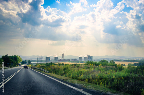 Industrial landscape with a road to the Power plant with dramatic sky on background