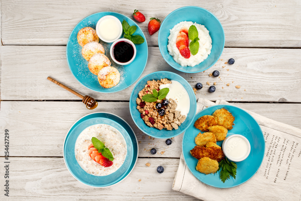 Different types of breakfast shot on wooden background