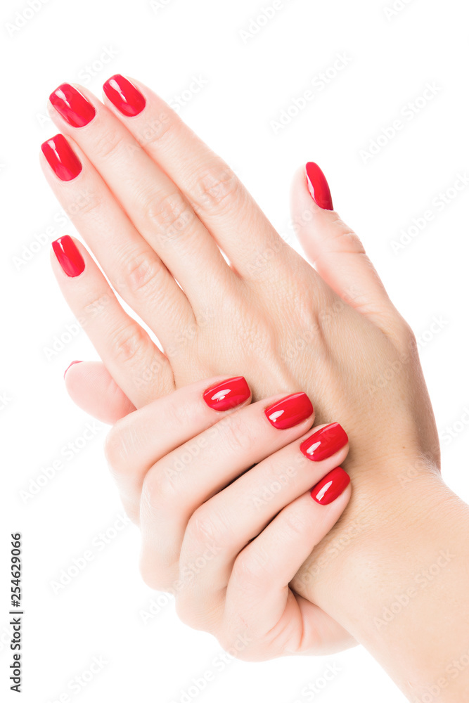 Hands of a young woman with red manicure on nails Hands of a young woman with red manicure on nails