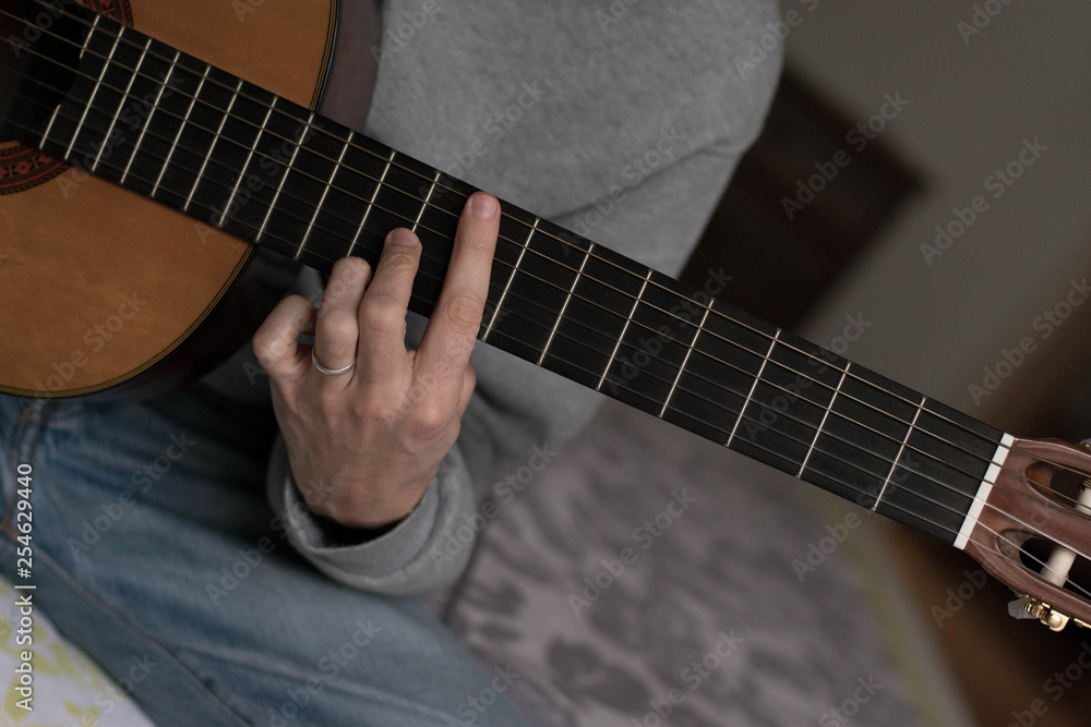 Fototapeta premium classic acustig guitar player performing, focus on hands