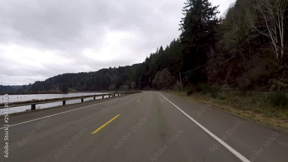 Driving with camera facing forward next to a river and train track around a curve. Driving with camera facing forward next to a river and train track around a curve.