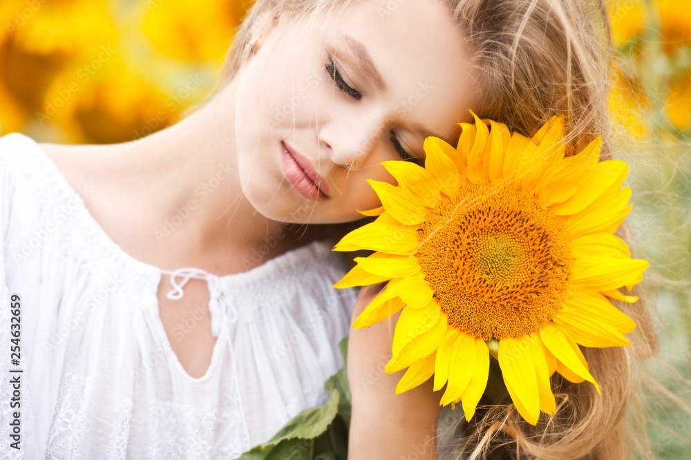 Young girl in sunflowers field on sunset. Young girl in sunflowers field on sunset.