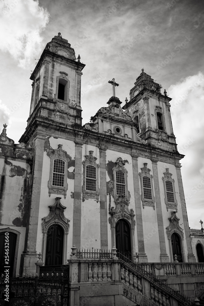Moody black and white view of the weathered neoclassical colonial facade of the Ordem Terceira do Carmo church in Salvador, Bahia, Brazil