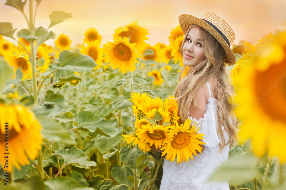 Young girl in sunflowers field on sunset. Young girl in sunflowers field on sunset.