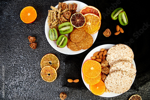 Healthy snacks - variety oat granola bar, rice crips, almond, kiwi, dried orange