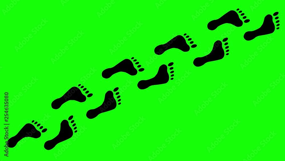 Black footprints (prints made by feet) appearing on a green background. Black footprints (prints made by feet) appearing on a green background.