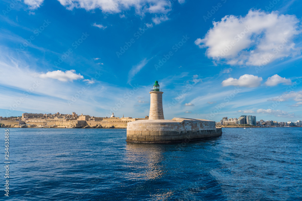 Green Lighthouse in the Grand Harbour in Valletta city capital of Malta. Malta island. Mediterranean sea
