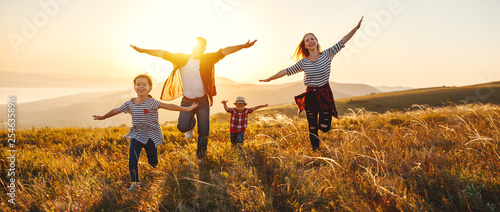 Happy family: mother, father, children son and daughter on sunset. photo