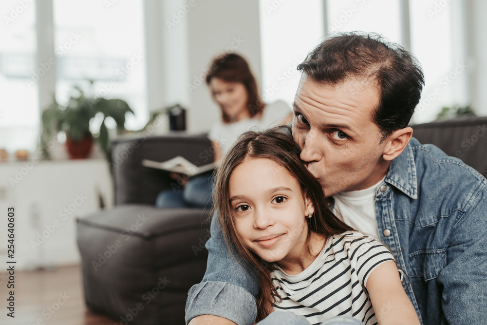 Happy father kissing daughter in head with love Happy father kissing daughter in head with love