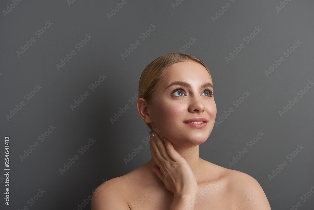 Pretty lady touching her neck and looking away Pretty lady touching her neck and looking away