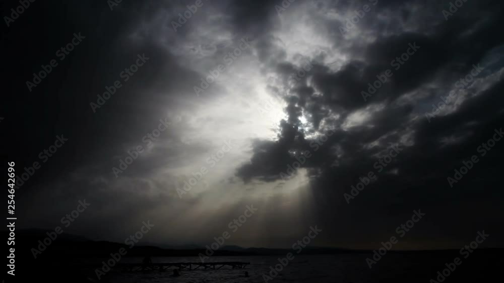 Coming Storm. Timelaps. Clouds cover the sun over the sea. Near the horizon lightning flashes Coming Storm. Timelaps. Clouds cover the sun over the sea. Near the horizon lightning flashes