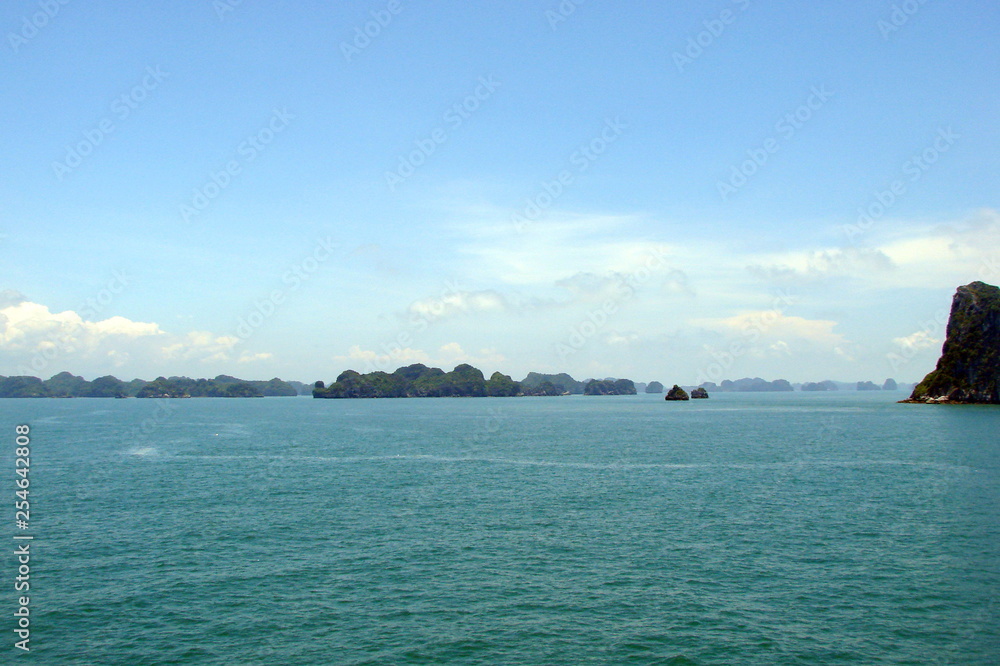 A variety of shades of blue color of the sea surface and the sky, which is united by a line of islands on the horizon.