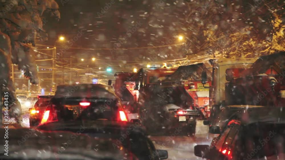 Road Collapse due to Blizzard. Snowplows stuck in a traffic jam during heavy snowfall Road Collapse due to Blizzard. Snowplows stuck in a traffic jam during heavy snowfall
