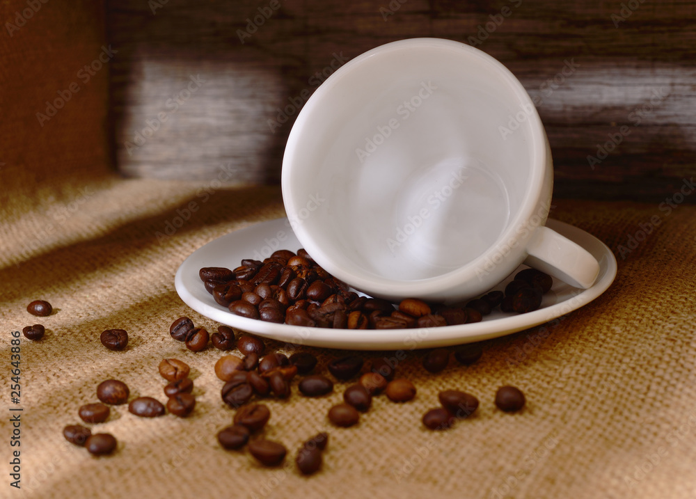 White cup of coffee with coffee beans. White cup of coffee with coffee beans.