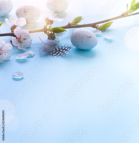Easter Eggs with Spring Flowers on blue Background