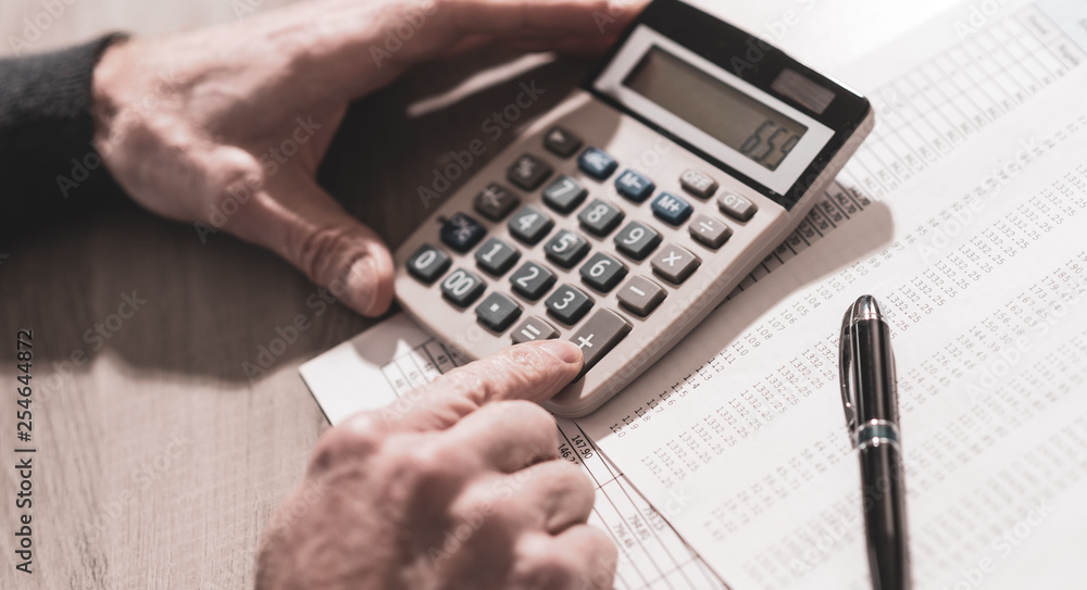 Hand using calculator, accounting concept Hand using calculator, accounting concept