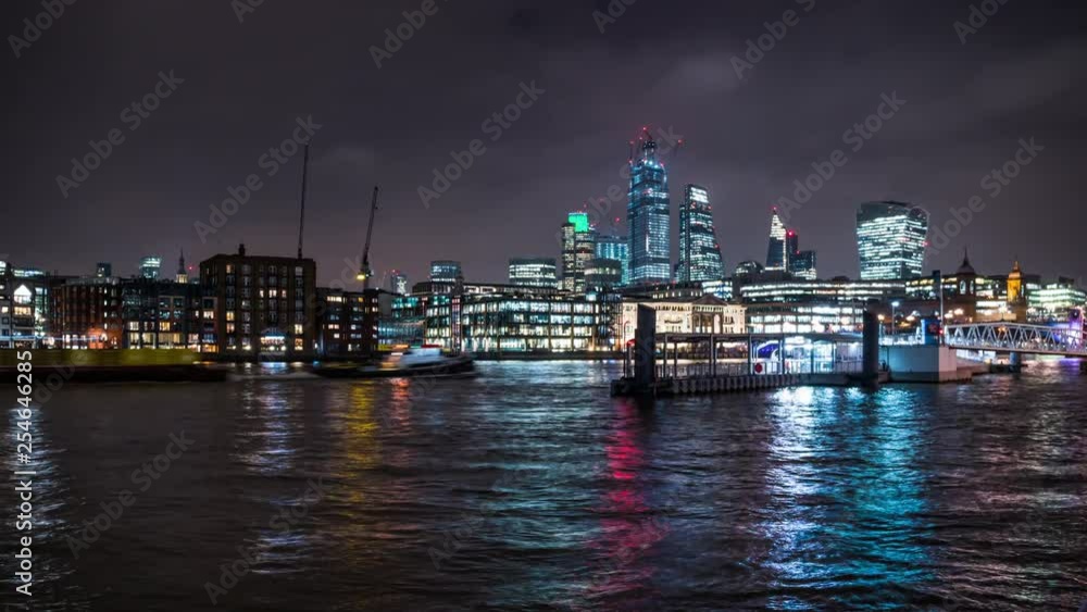 River bus arrives at the Bankside Pier in the Thames, skyscrapers of the City of London behind, time lapse. River bus arrives at the Bankside Pier in the Thames, skyscrapers of the City of London behind, time lapse.