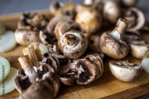 Champignon mushrooms on kitchen desk prepared to cook vegetarian healthy food. Vegan natural food concept
